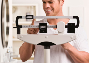 Man weighing himself on a scale