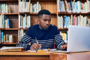 48219788 doing his research to get top marks a university student doing some research on a laptop 1 Save Big with Microconsulting: Cut Costs and Boost Your Bottom Line